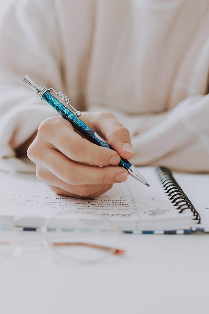 Rachel Jackson Marketing Tech Specialist a close up of a hand writing in a note book