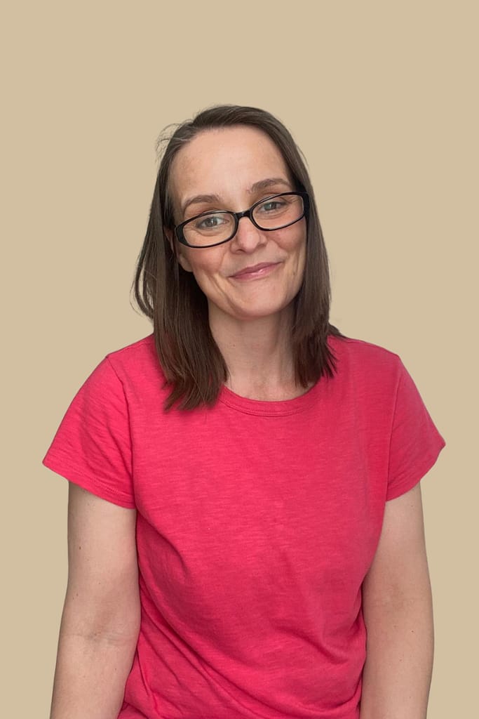 Rachel Jackson Marketing Tech Specialist. A headshot of Rachel Jackson, with mid length straight brown hair and black glasses, wearing a red t shirt.